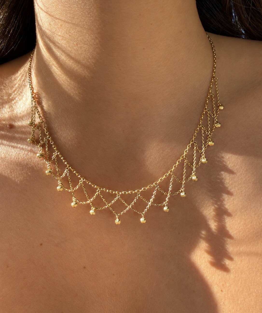 Collier draperie à godrons
